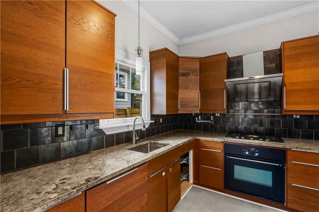 1440 Everhart Street Southwest Atlanta, GA 30310 - Photo 12 of 27 a kitchen with a sink and a stove top oven