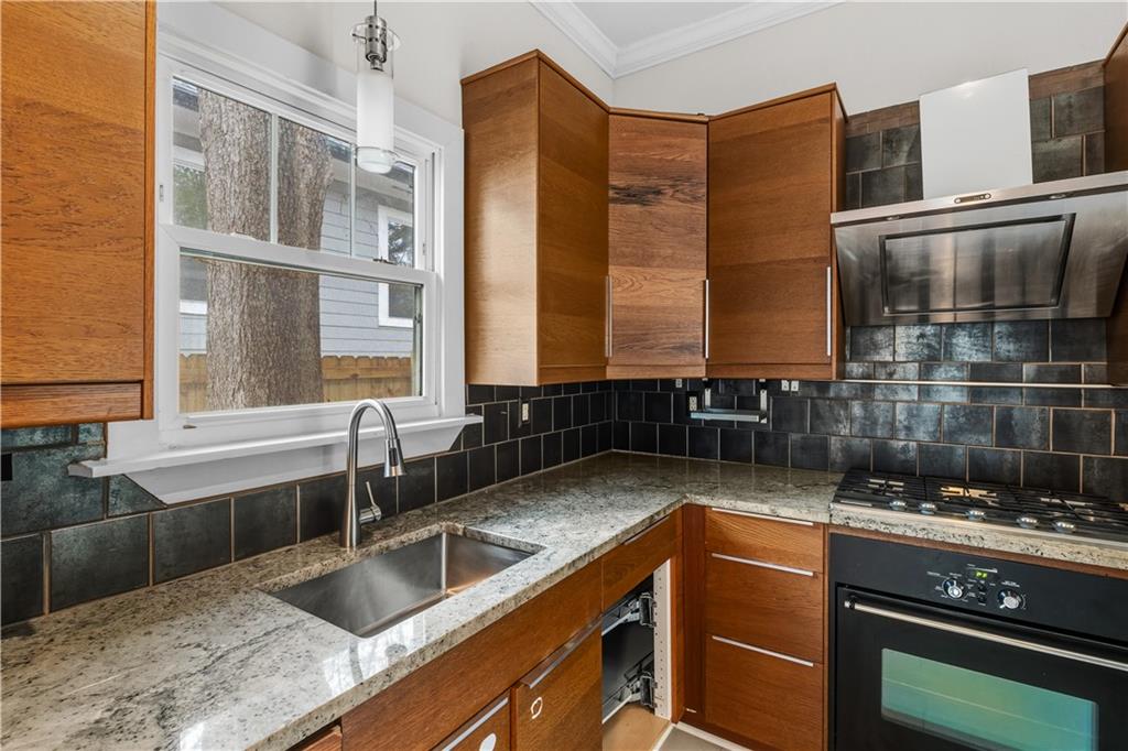 1440 Everhart Street Southwest Atlanta, GA 30310 - Photo 13 of 27 a kitchen with granite countertop a sink and a stove