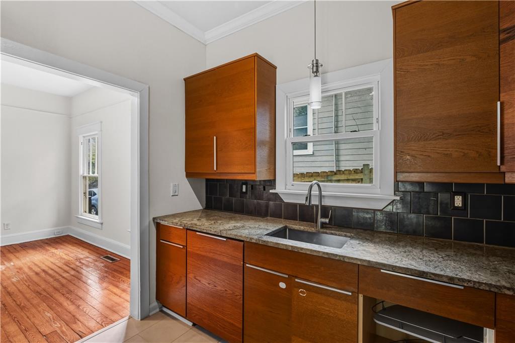 1440 Everhart Street Southwest Atlanta, GA 30310 - Photo 14 of 27 a kitchen with granite countertop a sink and a window