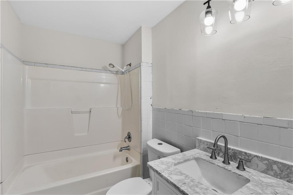 1440 Everhart Street Southwest Atlanta, GA 30310 - Photo 17 of 27 a bathroom with a sink toilet and shower