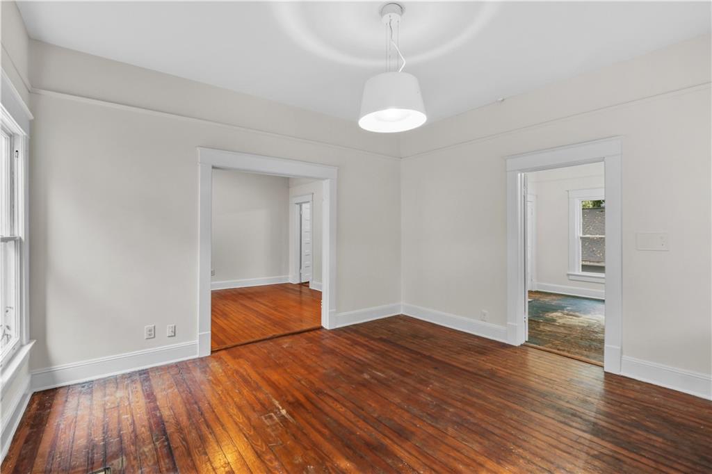 1440 Everhart Street Southwest Atlanta, GA 30310 - Photo 6 of 27 an empty room with wooden floor and windows