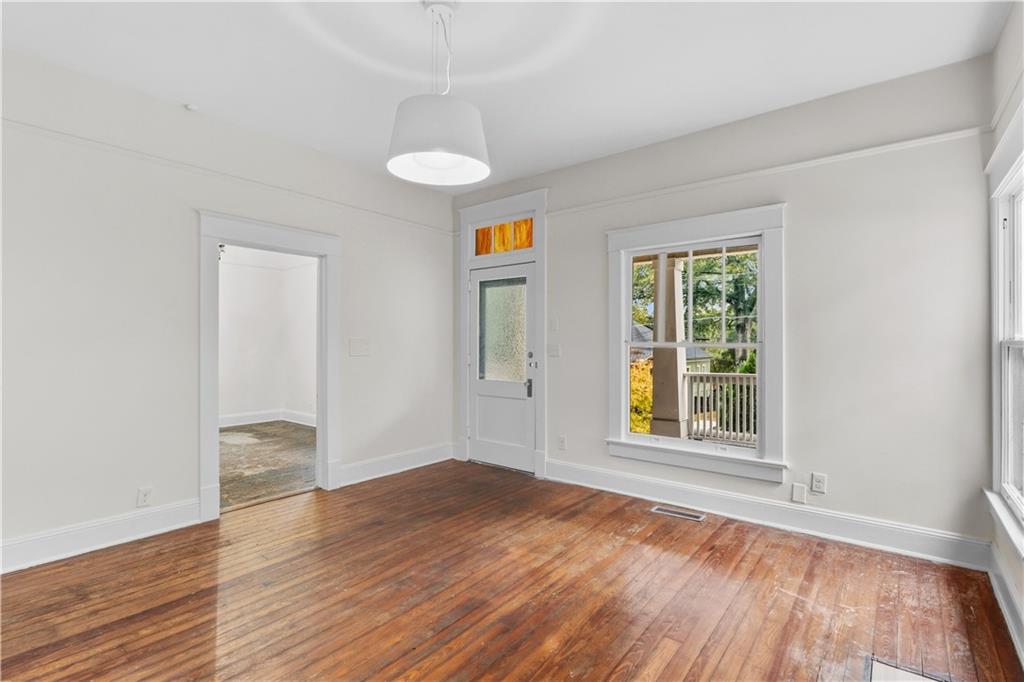 1440 Everhart Street Southwest Atlanta, GA 30310 - Photo 7 of 27 an empty room with wooden floor and windows