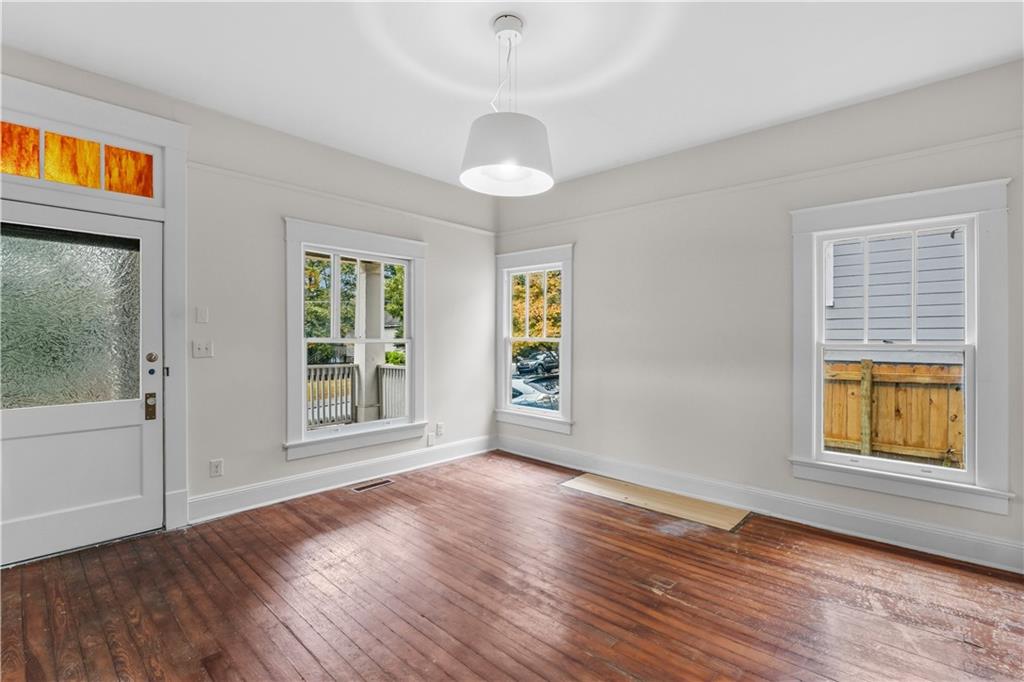 1440 Everhart Street Southwest Atlanta, GA 30310 - Photo 8 of 27 a view of an empty room with a window and wooden floor