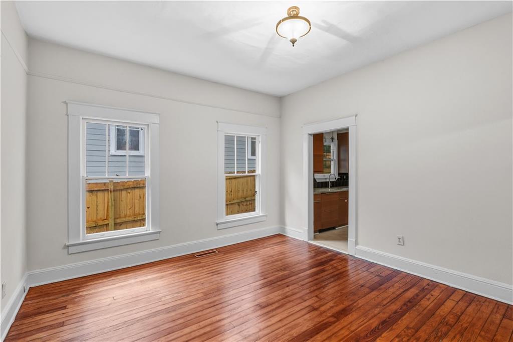 1440 Everhart Street Southwest Atlanta, GA 30310 - Photo 9 of 27 a view of an empty room with wooden floor and a window