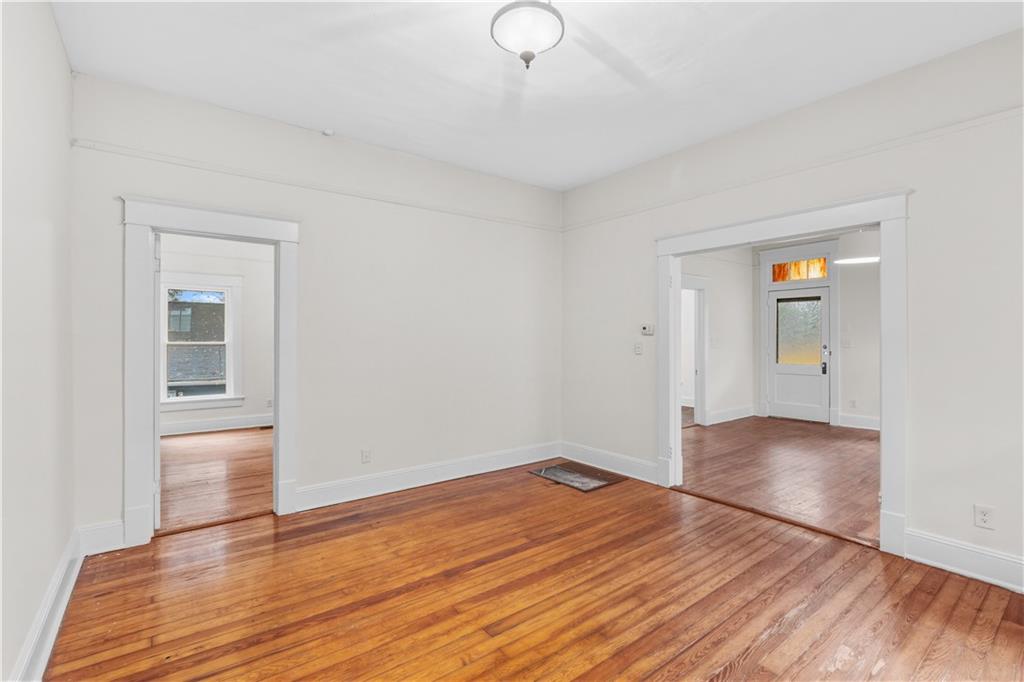 1440 Everhart Street Southwest Atlanta, GA 30310 - Photo 10 of 27 a view of empty room with wooden floor and fan