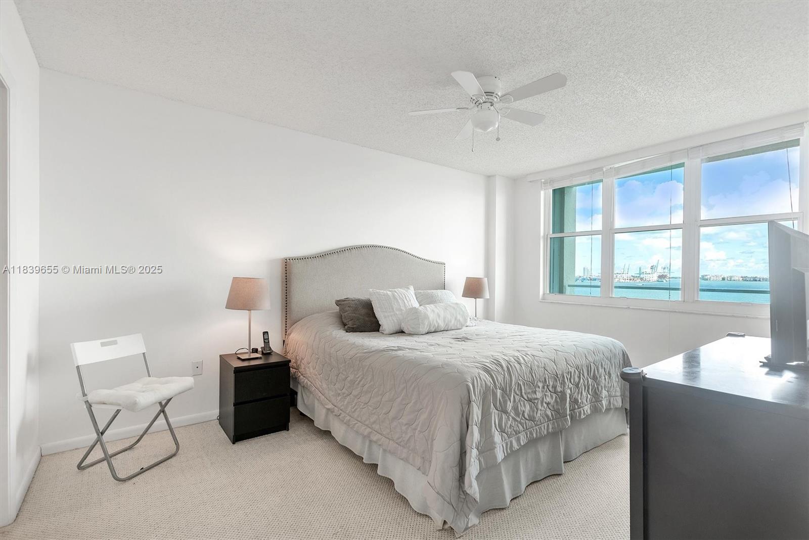 Brickell Miami, FL 33131 - Photo 18 of 32 a bedroom with a bed and window