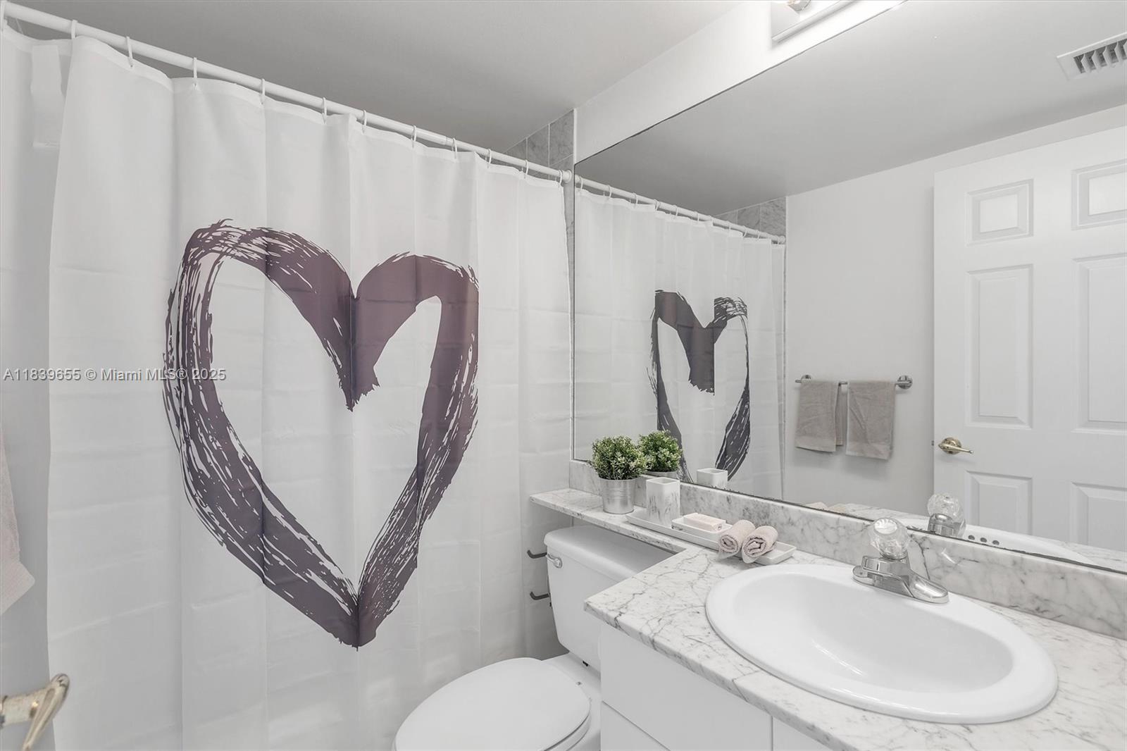 Brickell Miami, FL 33131 - Photo 24 of 32 a bathroom with a toilet sink and mirror