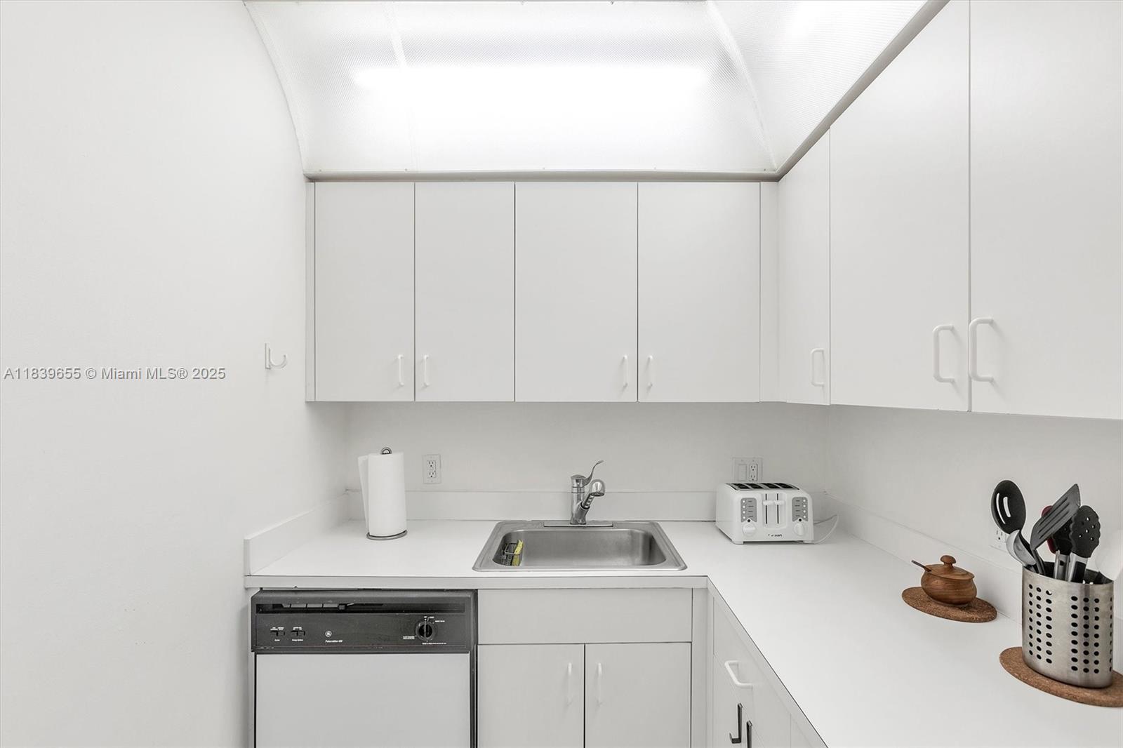 Brickell Miami, FL 33131 - Photo 25 of 32 a kitchen with a sink and cabinets