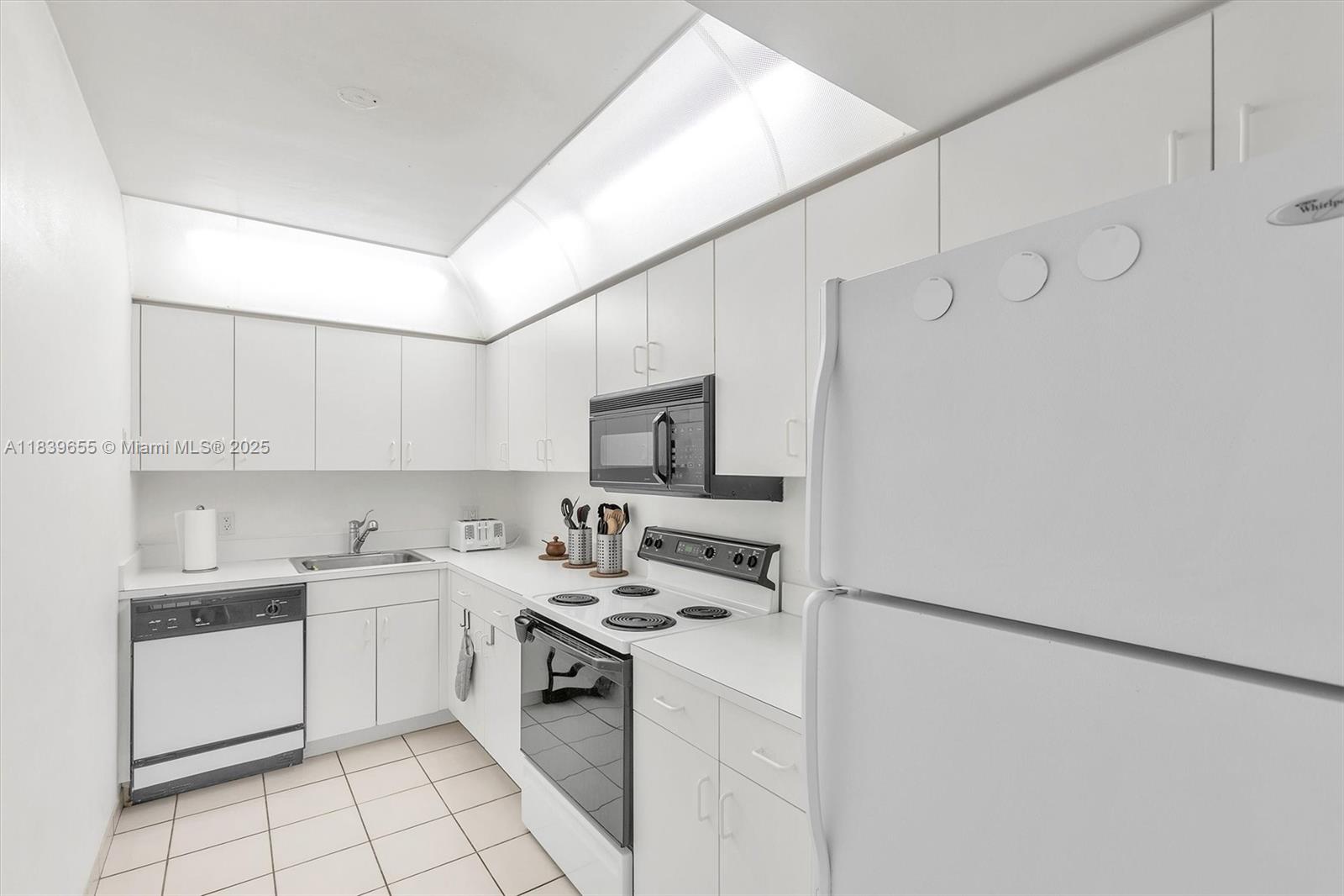 Brickell Miami, FL 33131 - Photo 28 of 32 a kitchen with a sink cabinets and white stainless steel appliances