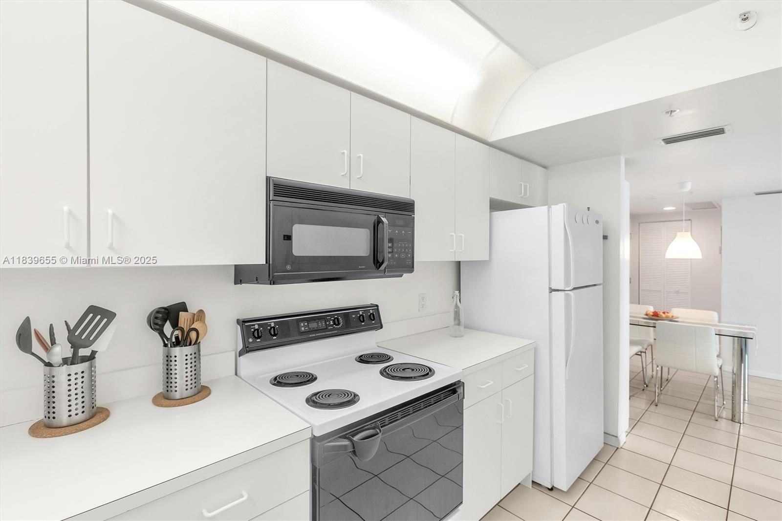 Brickell Miami, FL 33131 - Photo 29 of 32 a kitchen with stainless steel appliances a stove a sink and a refrigerator