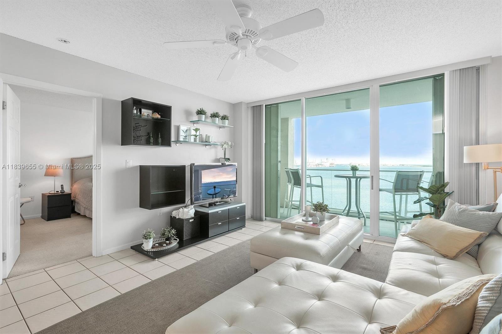 Brickell Miami, FL 33131 - Photo 3 of 32 a living room with furniture a large window and a fireplace