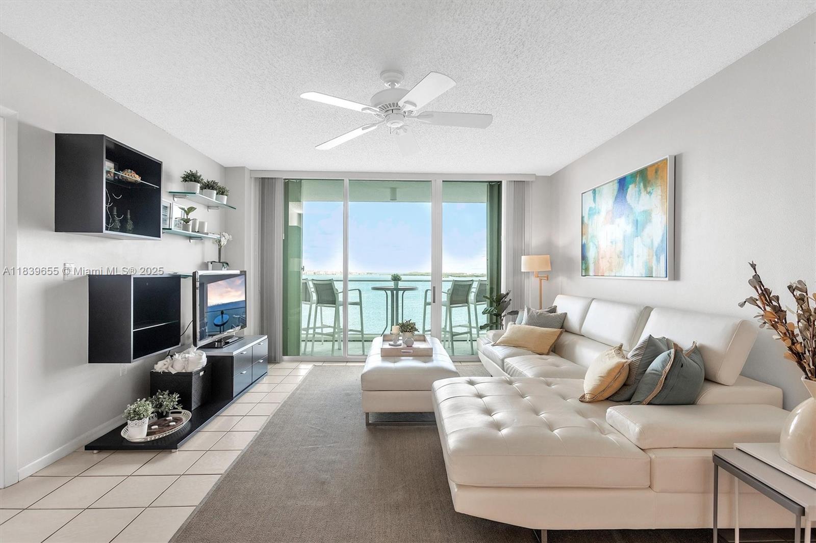 Brickell Miami, FL 33131 - Photo 4 of 32 a living room with furniture large window and a flat screen tv