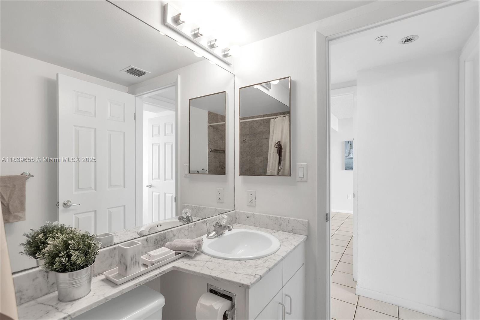 Brickell Miami, FL 33131 - Photo 9 of 32 a bathroom with a granite countertop sink and a mirror
