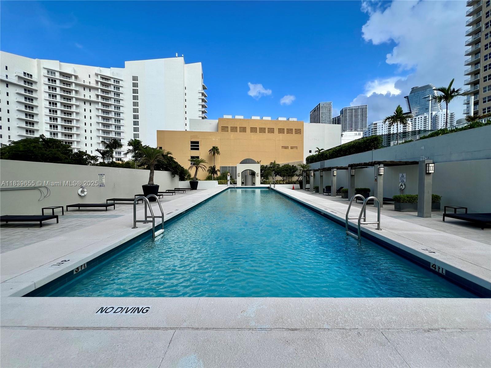 Brickell Miami, FL 33131 - Photo 10 of 32 a view of a swimming pool with outdoor seating
