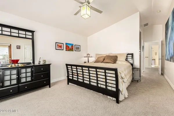 a bedroom with a large bed and a large window