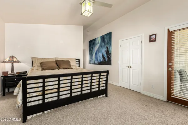 a bed sitting in a bedroom next to a window