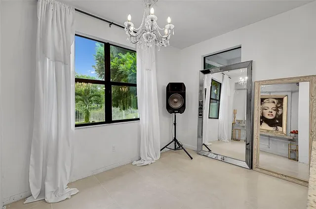 a view of a livingroom with a chandelier furniture and windows