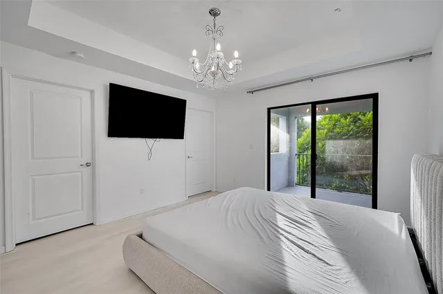 a bedroom with a large bed and a flat screen tv