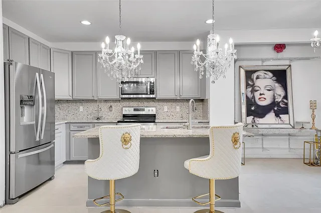 a kitchen with stainless steel appliances granite countertop a refrigerator sink and cabinets
