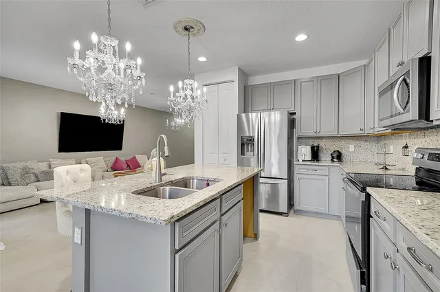 a kitchen that has a lot of cabinets and refrigerator in it