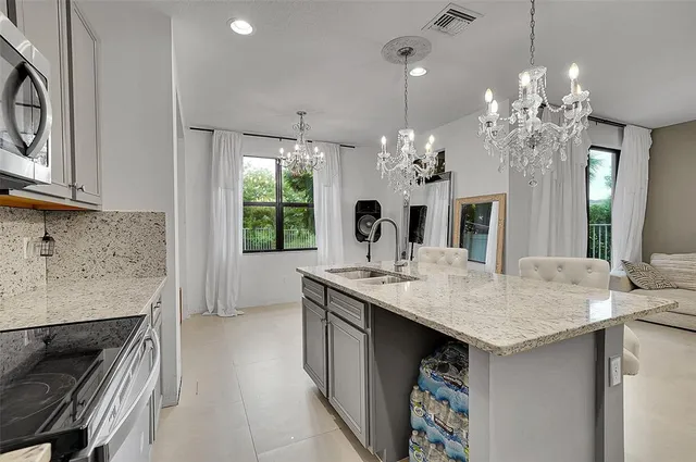 a kitchen with a sink stove and cabinets