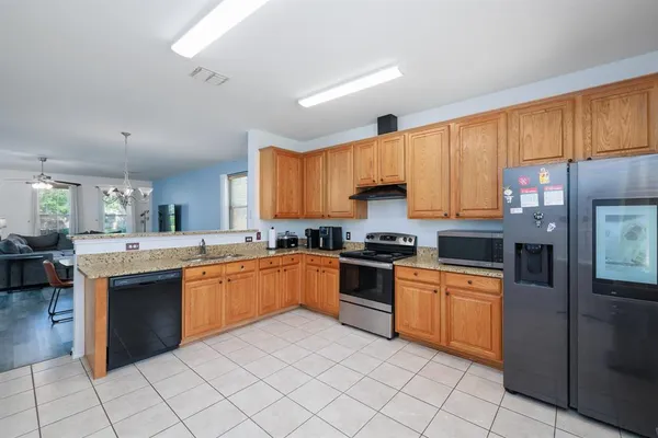 a kitchen with cabinets a sink and appliances