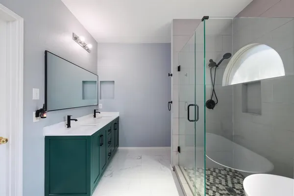 a bathroom with a tub sink toilet and mirror