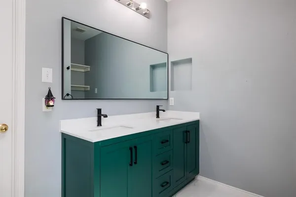a bathroom with a double vanity sink and mirror