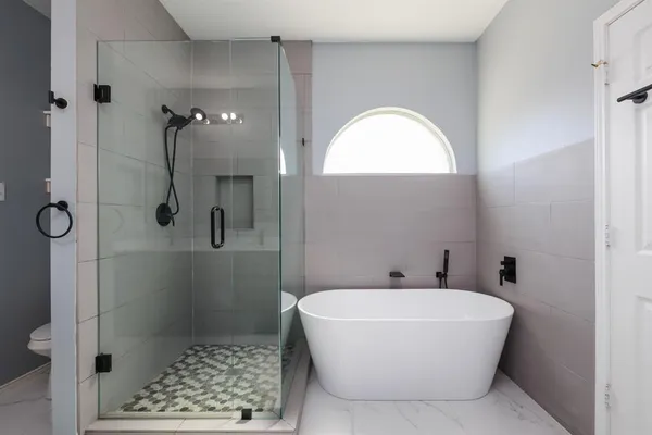 a bathroom with a bathtub a shower a toilet and a sink