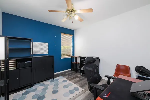 a livingroom with workspace and a window