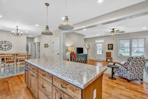 a large kitchen with kitchen island a large counter space and stainless steel appliances