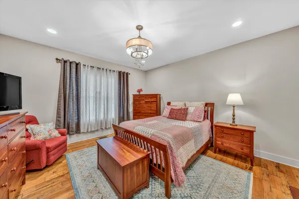 a bedroom with a bed and a chandelier