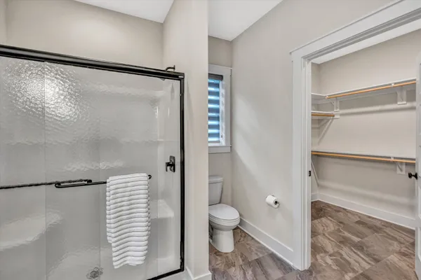 a bathroom with a toilet and a shower