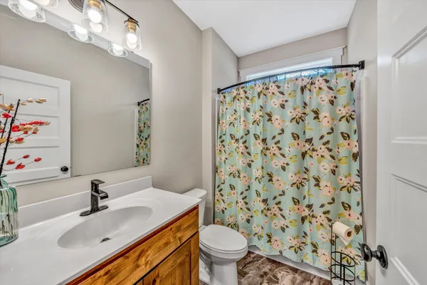 a bathroom with a sink toilet and shower