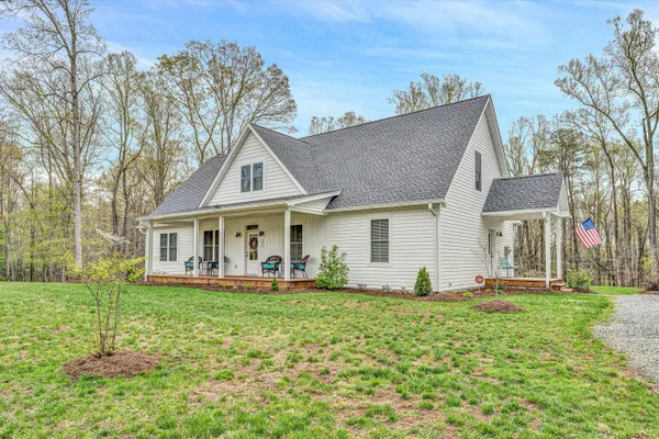 a front view of a house with a yard table and chairs
