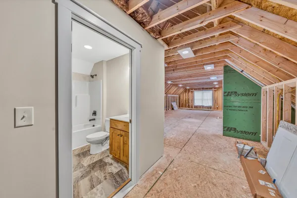 a bathroom with a toilet and a shower