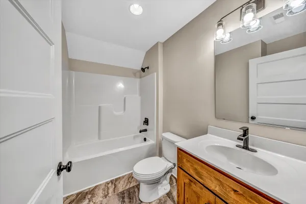a bathroom with a sink toilet tub and shower