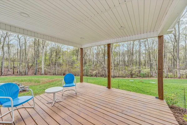 a view of a house with backyard and a tree