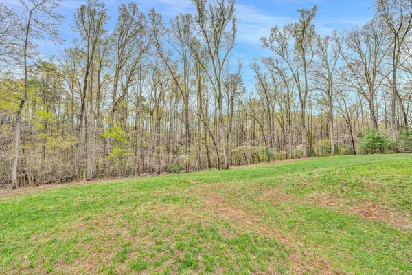 a view of a street with a building and trees in the background