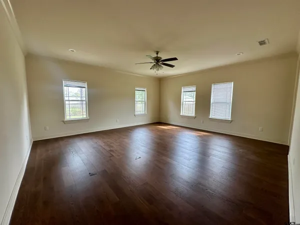 a view of a livingroom with wooden floor and a window