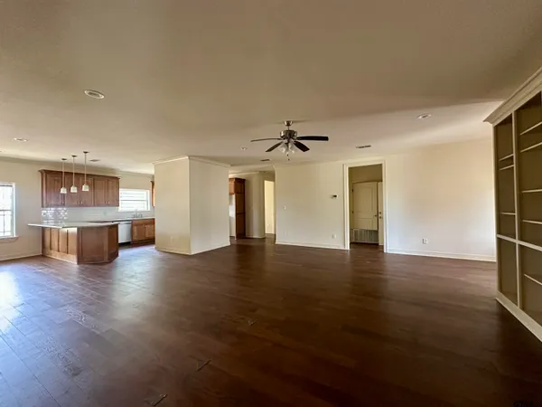 a view of a kitchen with a dishwasher and wooden floor