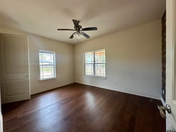 a view of room with hardwood floor and windows