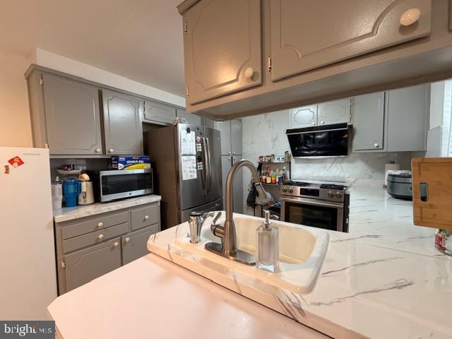 810 Kendrick Street Philadelphia, PA 19111 - Photo 15 of 45 a kitchen with granite countertop a refrigerator stove and sink