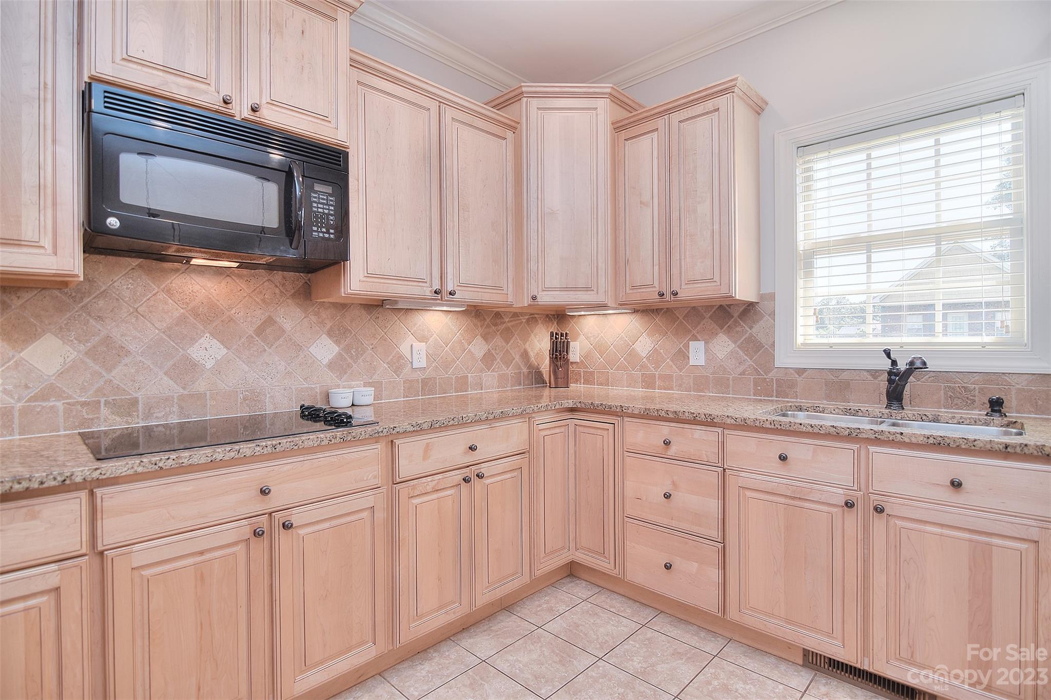 4913 Campobello Drive Monroe, NC 28110 - Photo 14 of 46 a kitchen with white cabinets sink and window