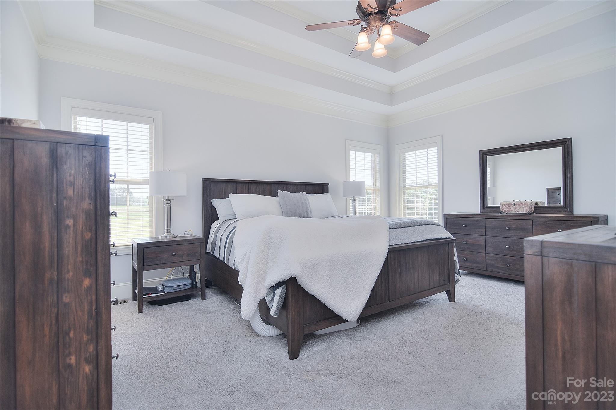 4913 Campobello Drive Monroe, NC 28110 - Photo 17 of 46 a spacious bedroom with a bed and a chandelier