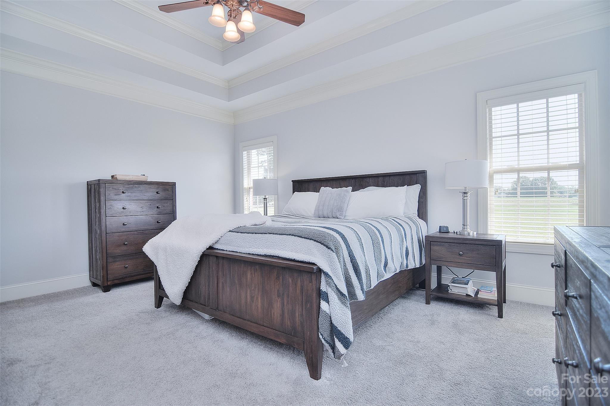 4913 Campobello Drive Monroe, NC 28110 - Photo 18 of 46 a bedroom with a bed and a chandelier