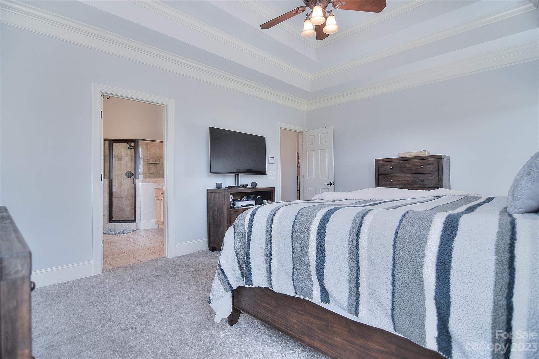 4913 Campobello Drive Monroe, NC 28110 - Photo 19 of 46 a bedroom with a bed and a chandelier