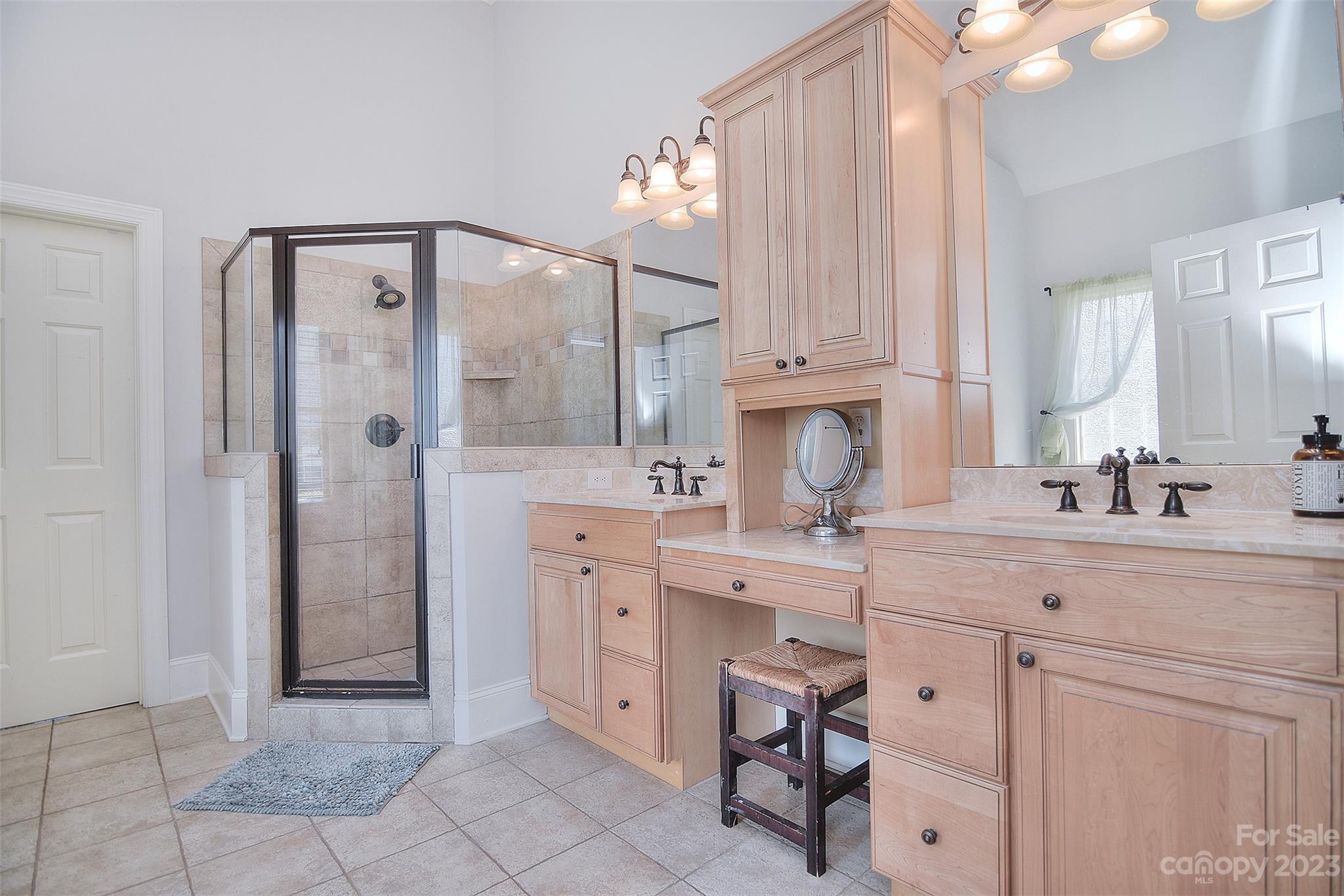 4913 Campobello Drive Monroe, NC 28110 - Photo 20 of 46 a spacious bathroom with a shower sink and cabinets