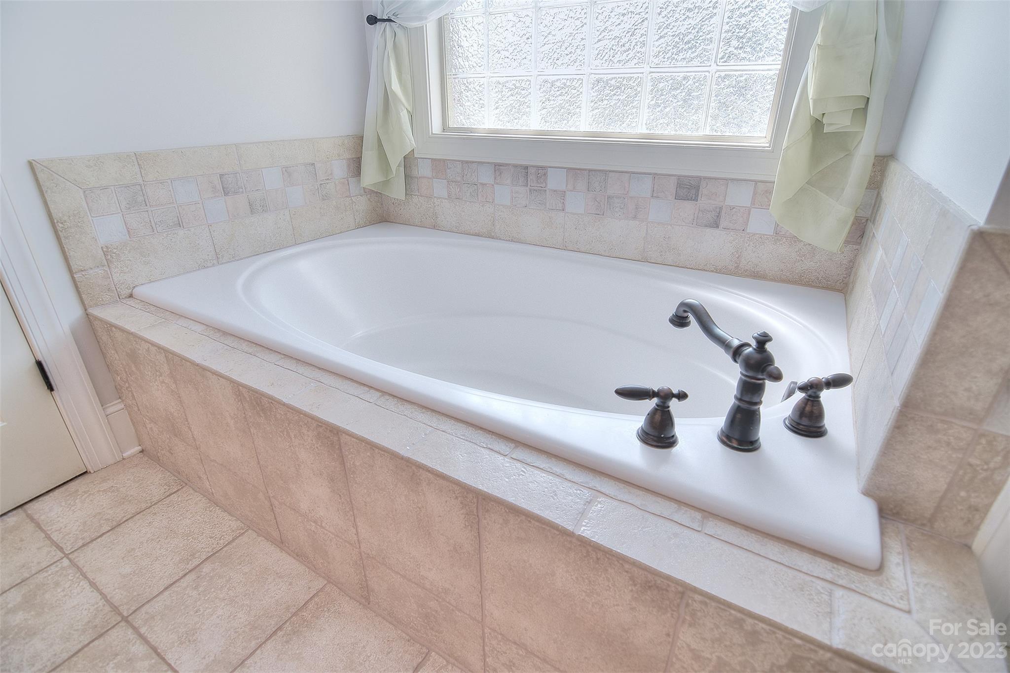 4913 Campobello Drive Monroe, NC 28110 - Photo 22 of 46 a bath tub sitting next to a window