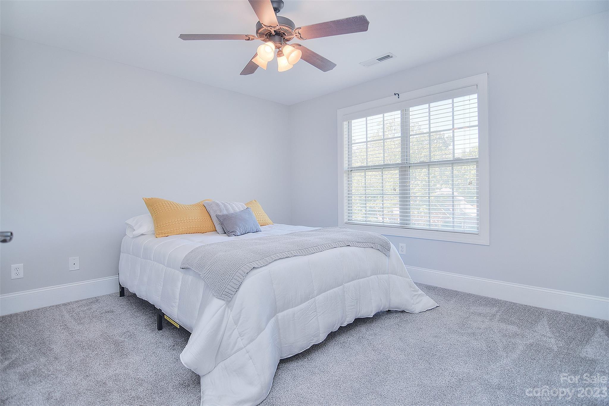 4913 Campobello Drive Monroe, NC 28110 - Photo 27 of 46 a bed sitting in a bedroom next to a window